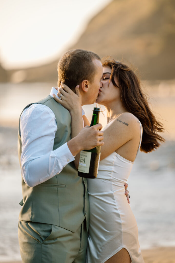 Bride and groom kissing after spraying the sparkling tea.