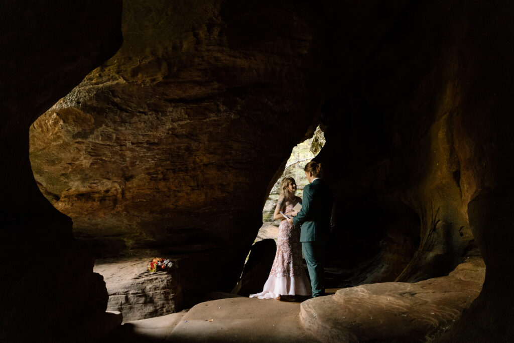 Couple saying vows in Rock House cave.