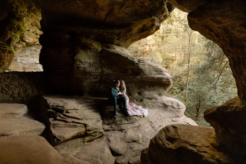 Couple sitting on a ledge in Rock House.