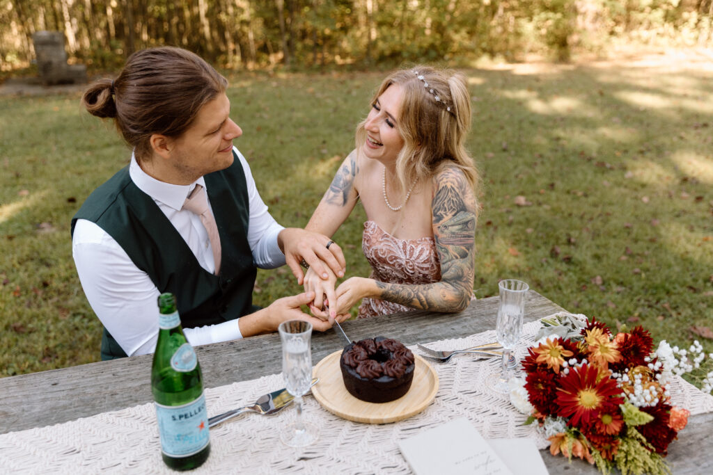Bride and groom cutting chocolate cake.