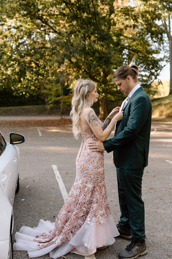 Bride helping groom with his tie.