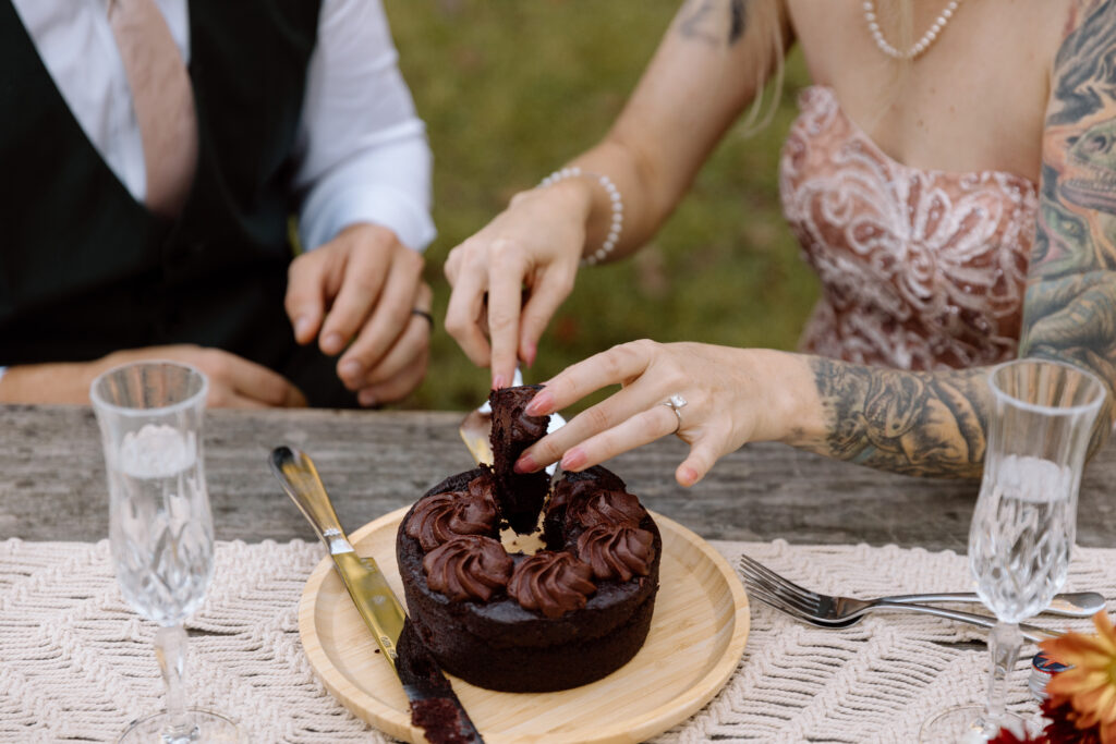 Close up of bride taking a piece of cake.