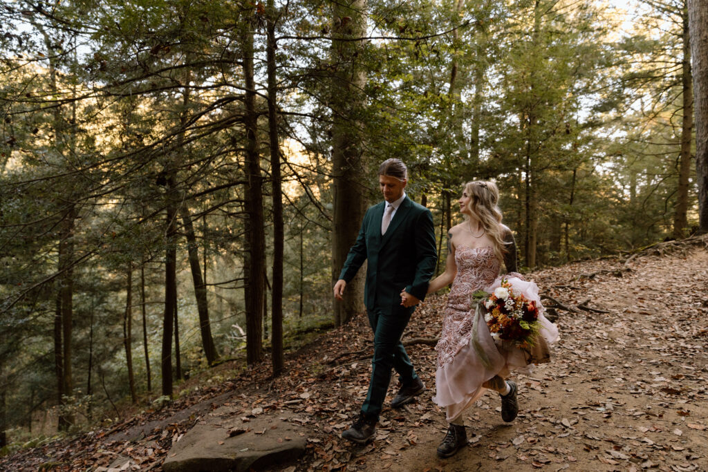 Couple walking and holding hands on the Rock House trail.