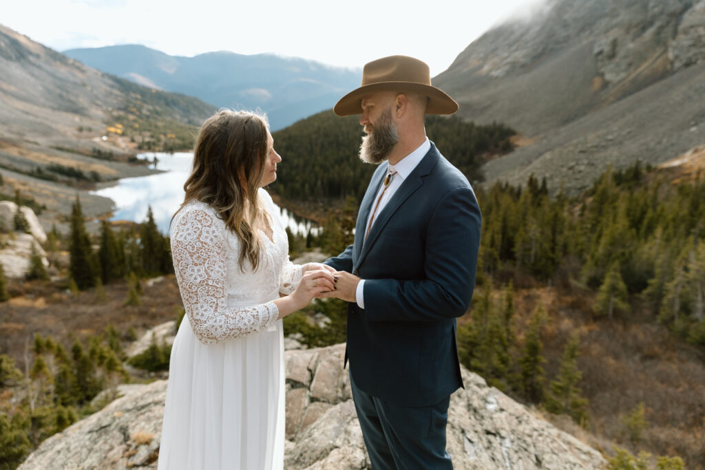 Couple exchanging rings during their Colorado elopement.