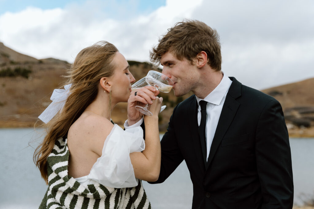 Couple drinking champagne during their elopement.
