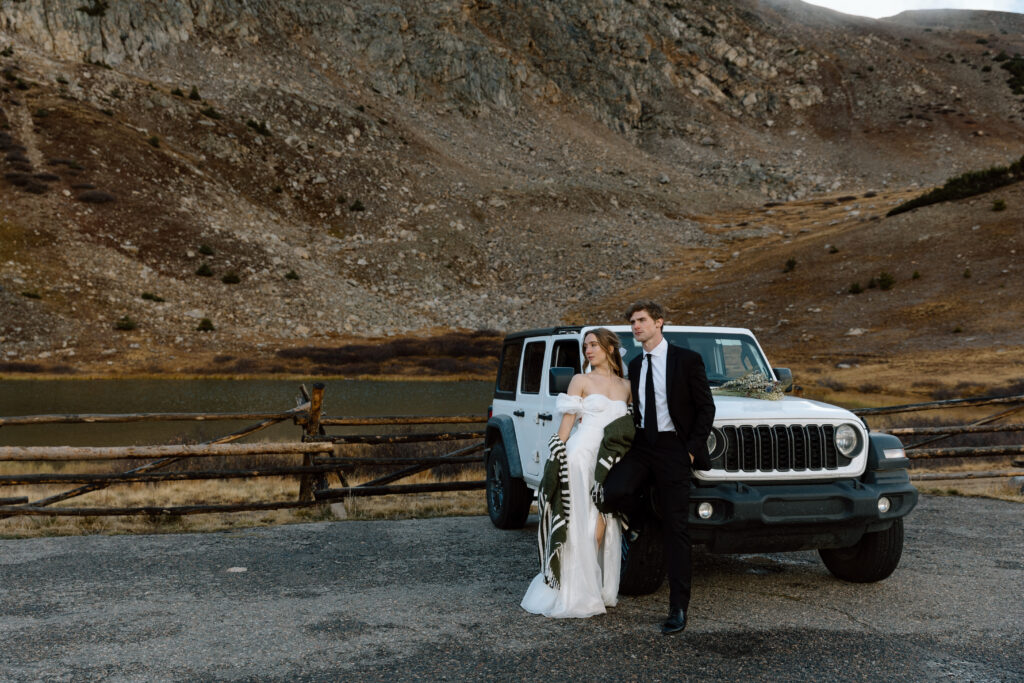Elopement couple standing next to a Jeep.
