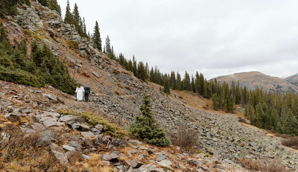 Couple walking along a trail that has rock fall.