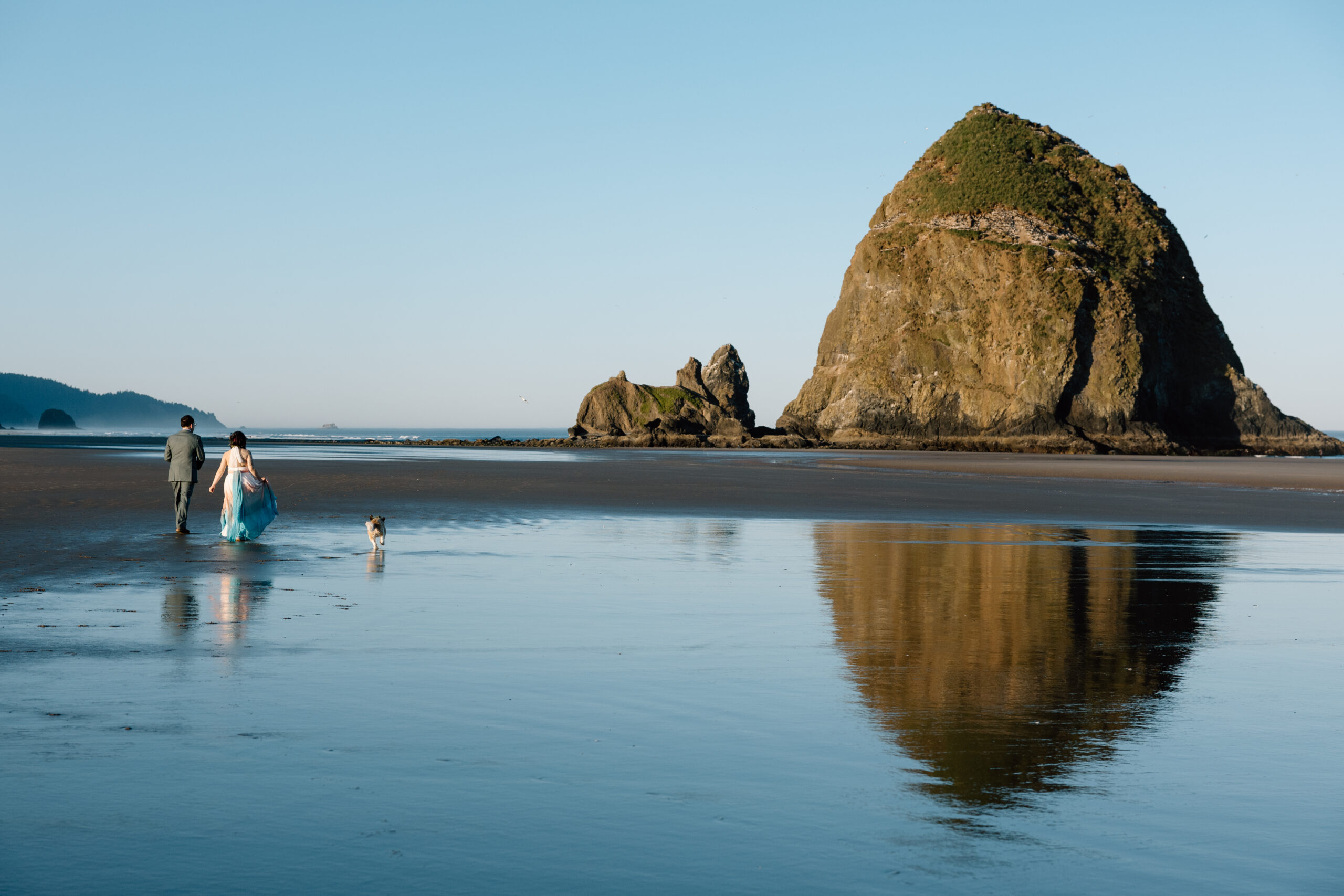 Couple walking with their dog on Cannon Beach