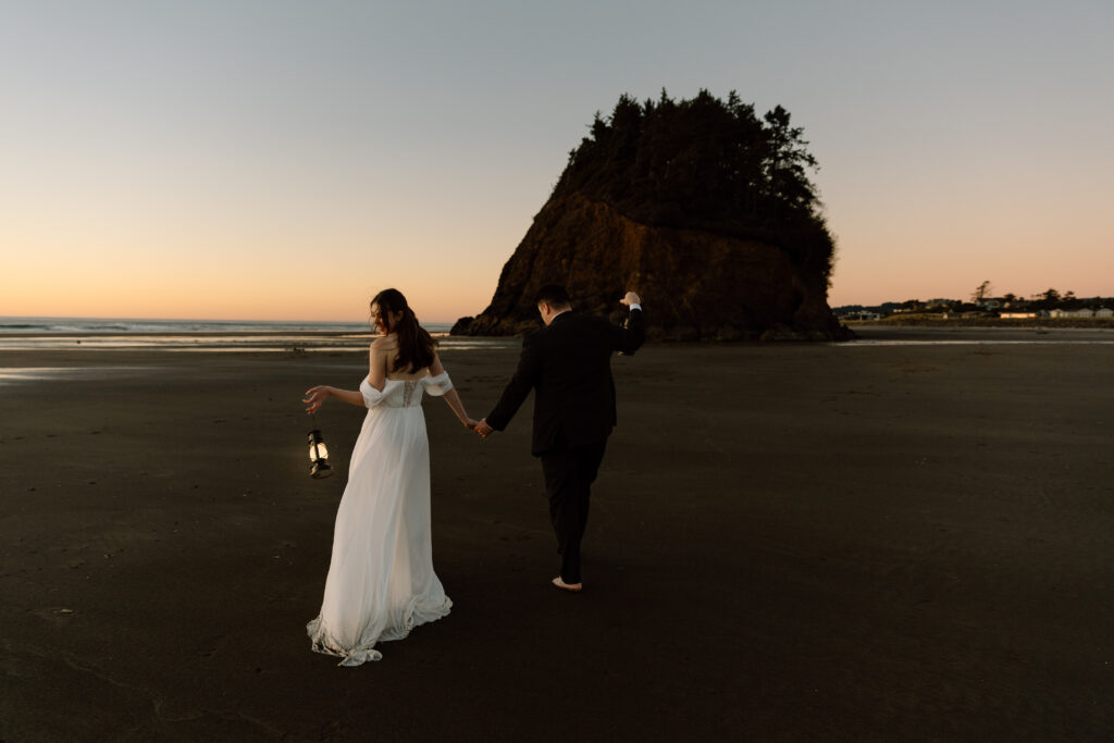 Couple holding lanterns at sunset on the Oregon Coast
