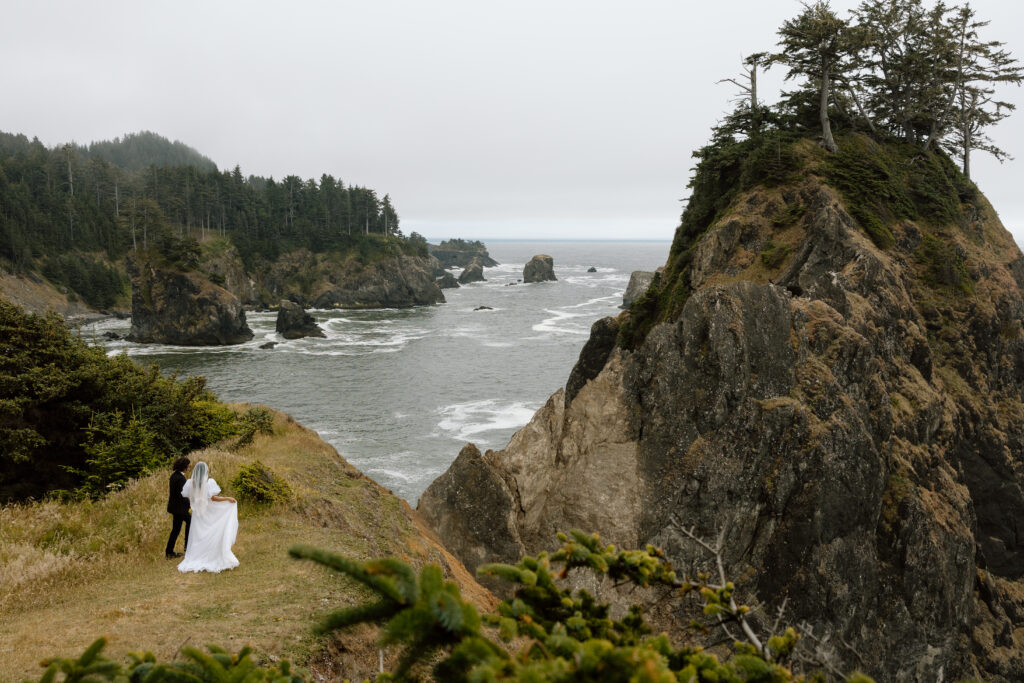 Couple walking along a cliff on the Oregon Coast
