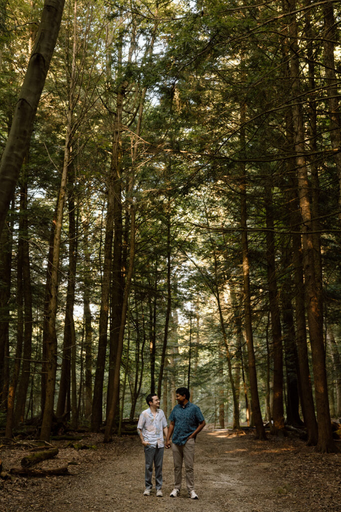 Couple holding hands and walking down the trail