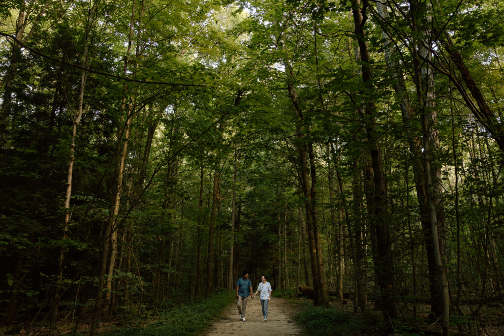 Couple walking through forest.