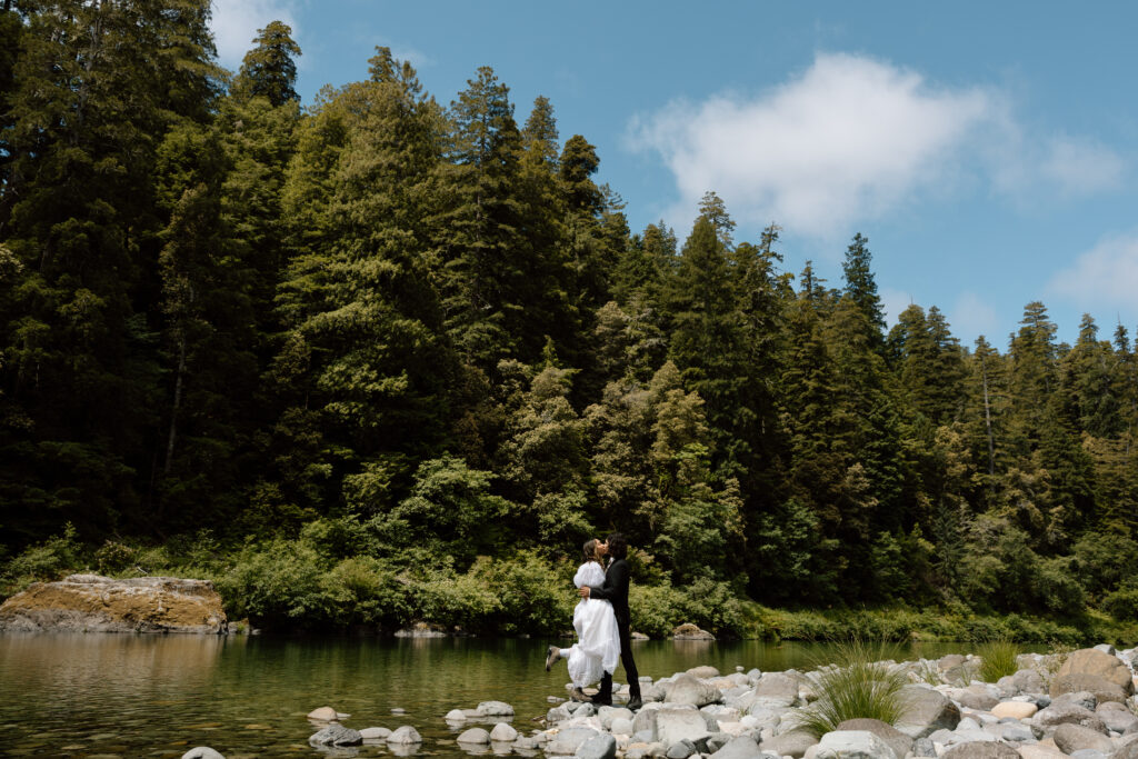 Couple standing on rocks in the Smith River