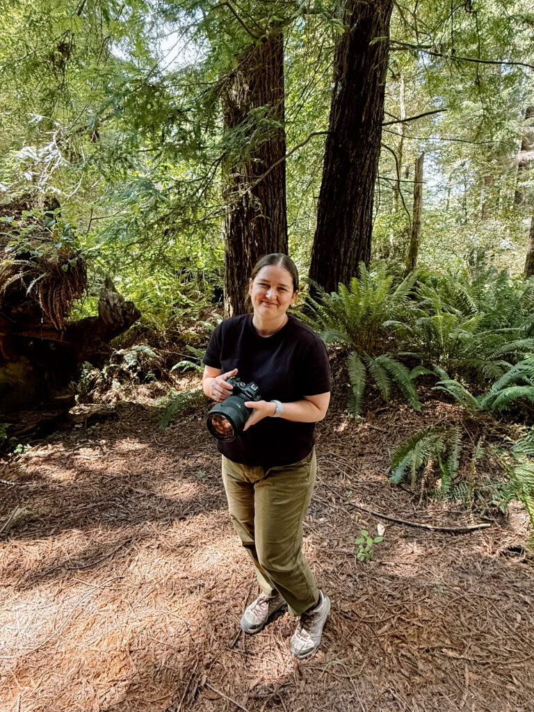 Desiree holding her camera in the Redwoods