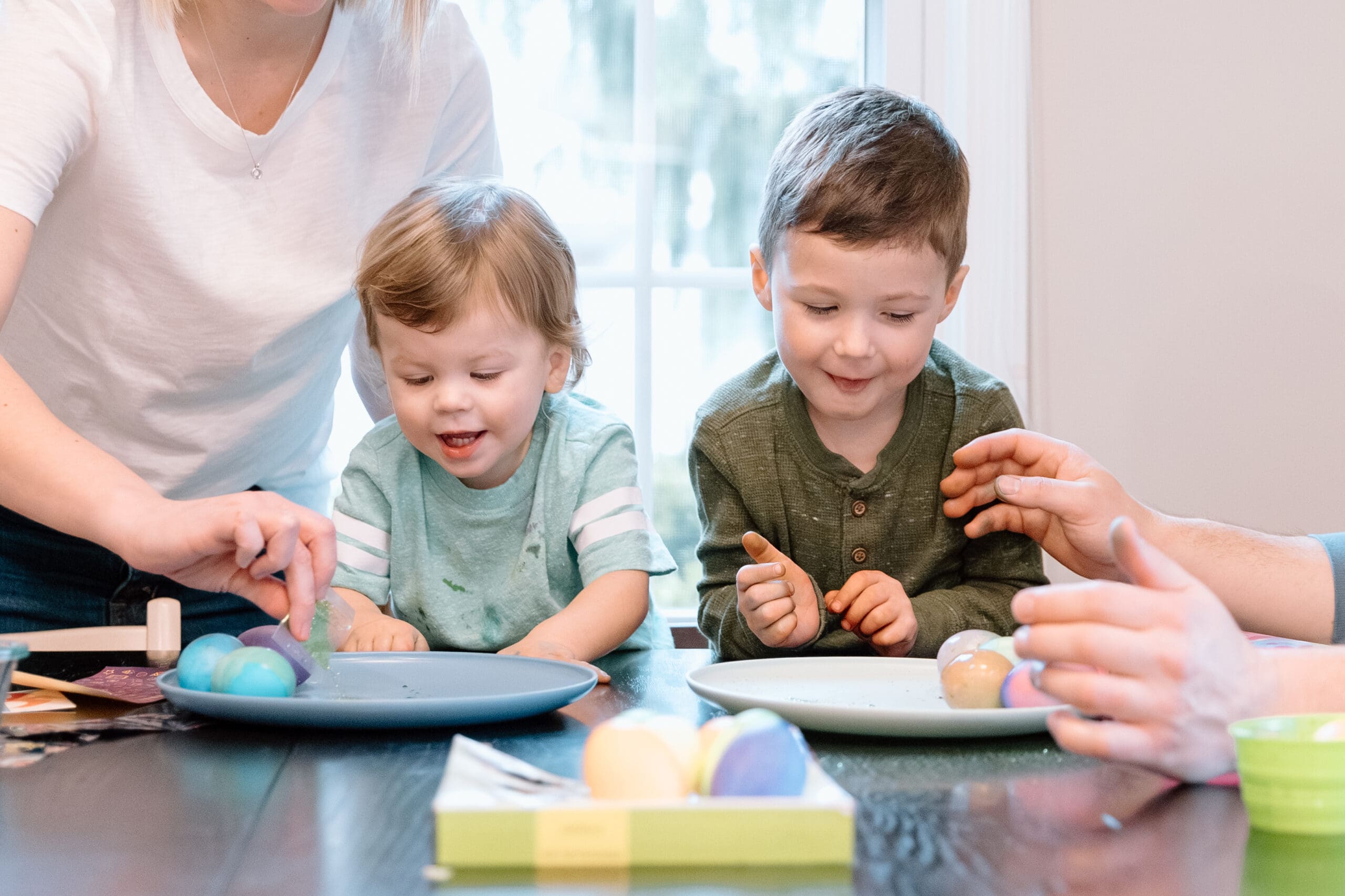 Two boys decorating Easter eggs.