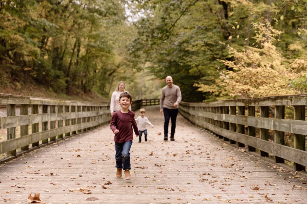 Boy running in front of his family at Sand Run Metro Park in Akron, OH.